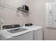 Laundry room with washer, dryer, and overhead shelving at 505 Great Eno Path, Hillsborough, NC 27278