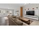 Open-concept living area with a sectional sofa, a large TV, and hardwood floors at 505 Great Eno Path, Hillsborough, NC 27278