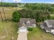 Charming gray home featuring an attached two car garage, well-maintained lawn and mature trees at 5110 Chipstone Dr, Raleigh, NC 27610