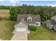 Charming gray home featuring an attached two car garage, well-maintained lawn and mature trees at 5110 Chipstone Dr, Raleigh, NC 27610