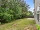 Backyard featuring a grassy area, a concrete slab, lush trees, and a wooden fence at 5110 Chipstone Dr, Raleigh, NC 27610