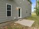 Backyard view featuring the home's exterior, concrete patio, and green grass at 5110 Chipstone Dr, Raleigh, NC 27610