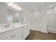 Bathroom featuring double vanity, large mirror, and a tub with shower doors at 5110 Chipstone Dr, Raleigh, NC 27610