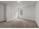 Bedroom features neutral walls and carpet and a window with green views at 5110 Chipstone Dr, Raleigh, NC 27610