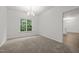 Bright dining room features neutral walls, carpet, a window with green views and a chandelier at 5110 Chipstone Dr, Raleigh, NC 27610