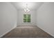 Empty dining room featuring a chandelier and a bright window at 5110 Chipstone Dr, Raleigh, NC 27610