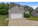 Attractive home exterior with a two-car garage, concrete driveway, and well-maintained front yard at 5110 Chipstone Dr, Raleigh, NC 27610