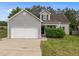 Inviting home showcasing gray siding, black shutters, and a two-car garage, with manicured front yard at 5110 Chipstone Dr, Raleigh, NC 27610