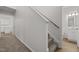 Hallway features plush carpet, a wooden handrail, and entryways to the bathroom and other rooms at 5110 Chipstone Dr, Raleigh, NC 27610