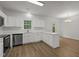 Modern eat-in kitchen featuring stainless appliances, white cabinets and an adjacent dining area at 5110 Chipstone Dr, Raleigh, NC 27610