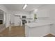 Modern kitchen boasts white cabinets, stainless appliances and an adjacent breakfast bar at 5110 Chipstone Dr, Raleigh, NC 27610