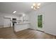 Eat-in kitchen featuring white cabinets, modern appliances, and an adjacent door to the outdoors at 5110 Chipstone Dr, Raleigh, NC 27610