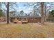 View of a home's rear exterior with a deck and a spacious backyard at 5232 Guess Rd, Durham, NC 27712