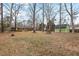 Rear view of a home with a deck, complemented by a large backyard, and a storage shed at 5232 Guess Rd, Durham, NC 27712