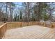 Spacious backyard with a wooden deck, mature trees, and natural surroundings at 5232 Guess Rd, Durham, NC 27712