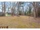 A spacious backyard with a storage shed and mature trees creates a serene outdoor retreat at 5232 Guess Rd, Durham, NC 27712