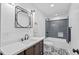 Bathroom features a vanity, decorative mirror, stylish flooring, and a shower-tub combo at 5232 Guess Rd, Durham, NC 27712