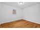 Bright and airy bedroom with hardwood floors, a neutral color scheme, and a window at 5232 Guess Rd, Durham, NC 27712