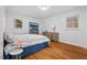 Bedroom with hardwood floors, natural light, and a calming color palette at 5232 Guess Rd, Durham, NC 27712