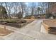 Street view of a single-story home with a brick foundation, driveway, and landscaped yard at 5232 Guess Rd, Durham, NC 27712