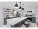 Modern kitchen boasts a large island, stainless steel appliances, and chic backsplash at 5232 Guess Rd, Durham, NC 27712