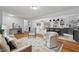 Open concept living room featuring hardwood floors, modern lighting, and an eat-in kitchen at 5232 Guess Rd, Durham, NC 27712