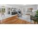 Open concept living room featuring hardwood floors, modern lighting, and an eat-in kitchen at 5232 Guess Rd, Durham, NC 27712