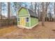 Exterior of a well-maintained storage shed with siding, doors, and roofing at 5232 Guess Rd, Durham, NC 27712