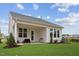 This backyard features a covered patio, lush green grass and attractive landscaping at 528 Gainer Dr # 8, Raleigh, NC 27610