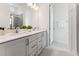 Bathroom with double vanity, large mirror, modern lighting, and a glass-enclosed shower at 528 Gainer Dr # 8, Raleigh, NC 27610