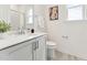 Bright bathroom featuring a single vanity, white countertops and cabinets, modern fixtures, and a framed mirror at 528 Gainer Dr # 8, Raleigh, NC 27610