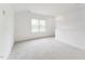 Upstairs bonus room featuring neutral walls, carpet, and a large window overlooking mature trees at 528 Gainer Dr # 8, Raleigh, NC 27610