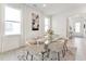 Elegant dining area featuring a glass table, six chairs, and plenty of natural light from large windows at 528 Gainer Dr # 8, Raleigh, NC 27610