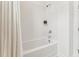Bright white tiled shower and tub combination with chrome shower head and fixtures at 528 Gainer Dr # 8, Raleigh, NC 27610