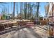 Outdoor patio space featuring brick retaining wall, playhouse and playground in backyard at 5410 Thayer Dr, Raleigh, NC 27612