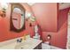 Quaint bathroom featuring unique fixtures, vintage wallpaper, and charming decorative touches at 5410 Thayer Dr, Raleigh, NC 27612