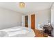 Minimalist bedroom with hardwood floors, a single bed, and a small desk at 5410 Thayer Dr, Raleigh, NC 27612