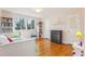 Cozy bedroom with hardwood floors, filled with natural light from the window, and furnished with shelving and a bed at 5410 Thayer Dr, Raleigh, NC 27612