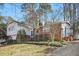Beautiful home with brick accents, white siding, mature trees, and established landscaping at 5410 Thayer Dr, Raleigh, NC 27612