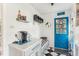 Cozy kitchen nook with ample counter space, storage, and a bright blue accent door at 5410 Thayer Dr, Raleigh, NC 27612