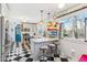 Bright kitchen featuring a breakfast bar, stainless steel appliances, and checkered flooring at 5410 Thayer Dr, Raleigh, NC 27612
