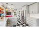 Spacious kitchen featuring stainless steel appliances, checkered flooring, and grey cabinets at 5410 Thayer Dr, Raleigh, NC 27612