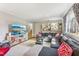 Comfortable living room features a wall-mounted TV and a large, gray sectional sofa at 5410 Thayer Dr, Raleigh, NC 27612