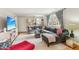 Cozy living room featuring a large gray sectional sofa and a plush rug at 5410 Thayer Dr, Raleigh, NC 27612