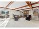 Spacious living room with exposed wood beams, a brick fireplace, and a sliding glass door to the patio at 5410 Thayer Dr, Raleigh, NC 27612