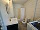 Bathroom featuring modern fixtures, bathtub and shower, as well as a washer and dryer unit at 611 Rowland St, Henderson, NC 27536