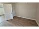 Bedroom featuring wood floors, neutral walls, and natural light at 611 Rowland St, Henderson, NC 27536