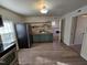 Modern kitchen featuring stainless steel appliances, a sink, and updated flooring at 611 Rowland St, Henderson, NC 27536