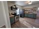 Modern kitchen with stainless steel appliances, green cabinets, and wood countertop at 611 Rowland St, Henderson, NC 27536