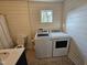 The laundry room features modern fixtures, shiplap walls, as well as a washer and dryer unit at 611 Rowland St, Henderson, NC 27536